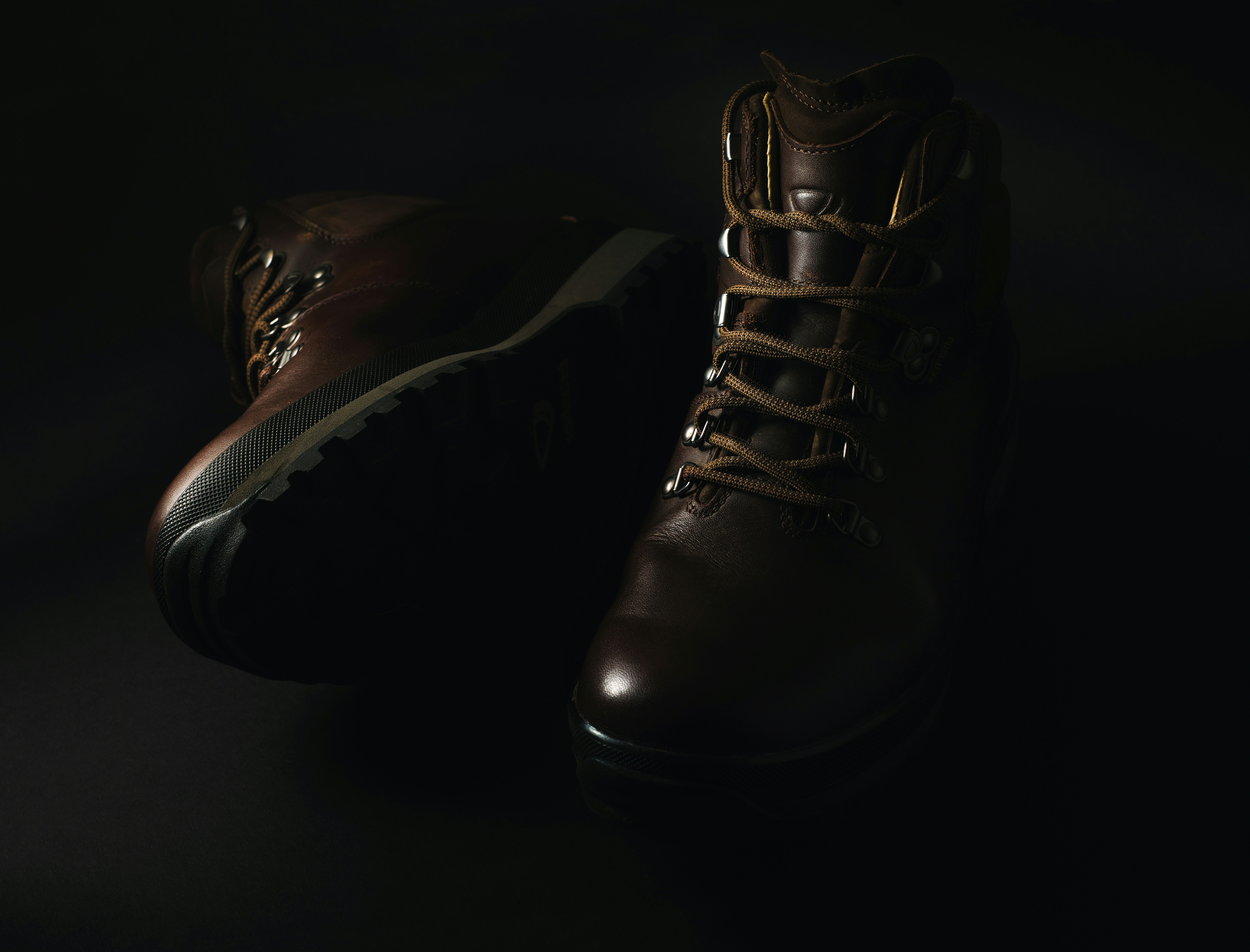 pair of brown leather lace-up combat boots